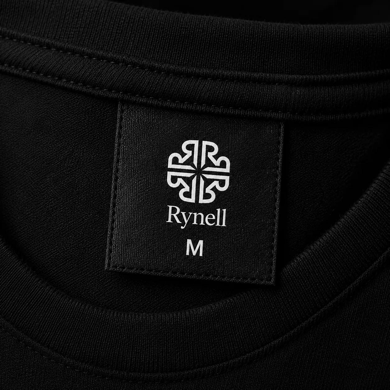 Black garment label with Rynell logo